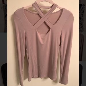 Form fitting long sleeve shirt with cross neckline